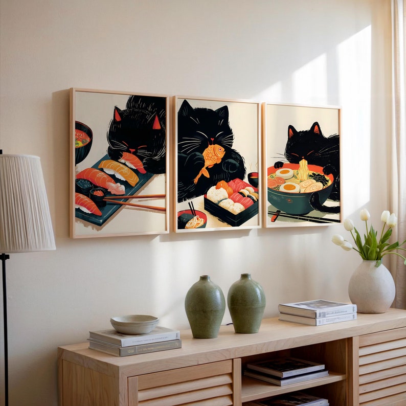 May include: Three framed illustrations of black cats enjoying Japanese food. The first cat is eating sushi, the second is eating a fish, and the third is eating ramen.