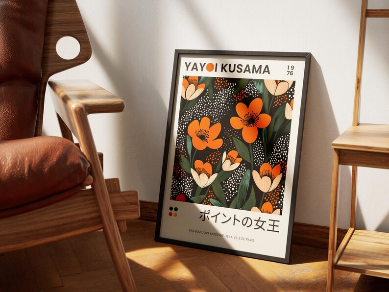 K&ouml;nnte beinhalten: Ein schwarzer gerahmter Poster mit einem floralen Design mit orangefarbenen Blumen auf schwarzem Hintergrund mit wei&szlig;en Punkten. Der Poster tr&auml;gt den Text "Yayoi Kusama" und "ポイントの女王" in Japanisch.