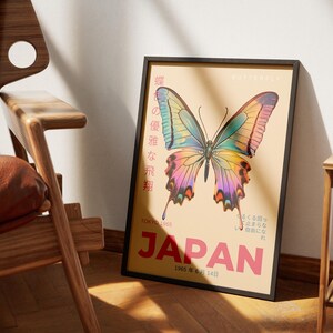 May include: A vintage poster with a colorful butterfly illustration and the text "JAPAN" in large red letters. The poster has a light brown background and the text "1965年8月14日" in black.