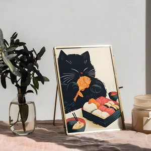 May include: A black cat with white whiskers is eating a fish and sushi from a black and white takeout container. The cat is in a gold frame on a pink table cloth. There is a clear glass vase with green leaves and a brown candle with a white label on the table.