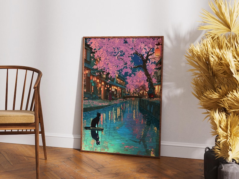 May include: A framed art print depicts a serene nighttime scene. A black cat sits on a small platform in a canal, reflecting in the water. Cherry blossom trees with pink flowers line the canal, with buildings and lanterns in the background.