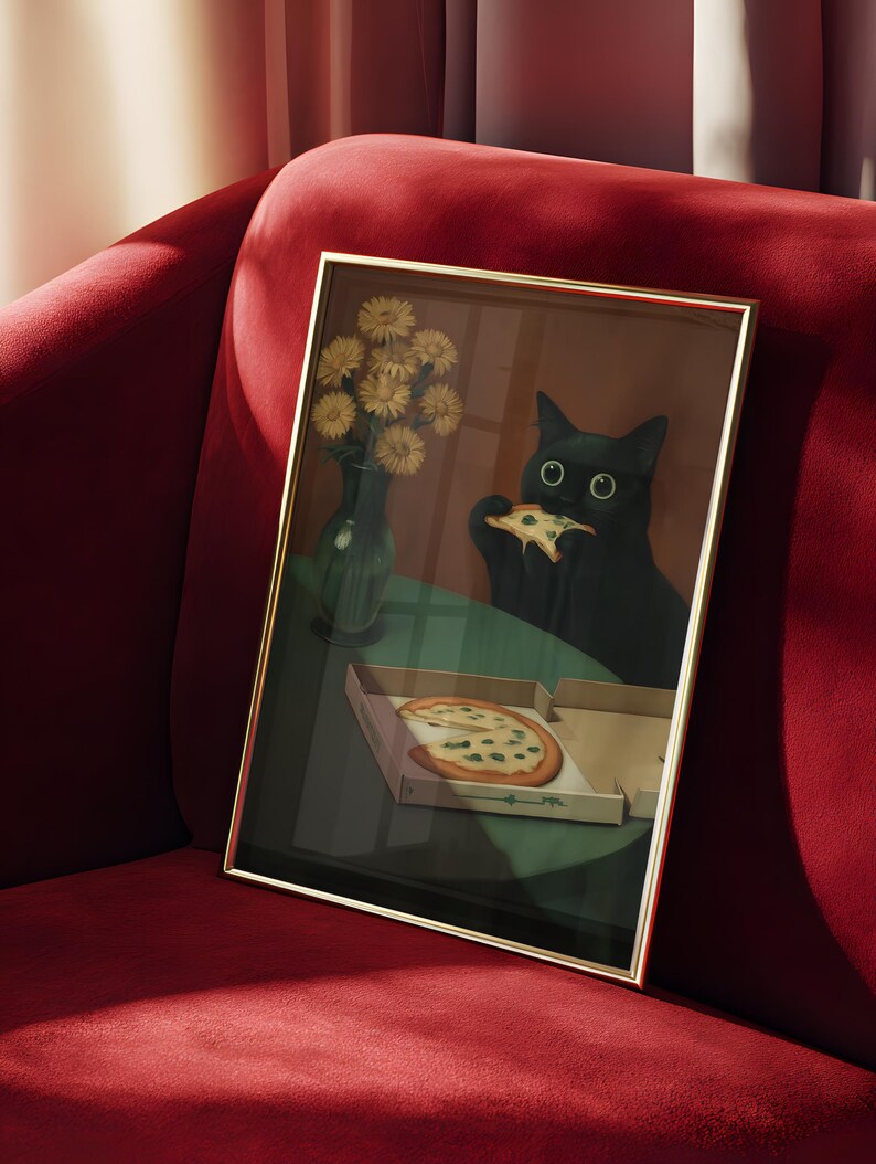 May include: Framed art print featuring a black cat eating pizza. The artwork includes a pizza box, a vase of yellow flowers, and a green table. The frame has a gold finish, and the background is a red velvet sofa.