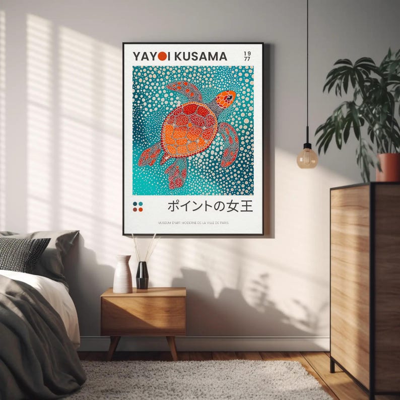 May include: A poster featuring a colorful, abstract painting of a sea turtle with the text "Yayoi Kusama 1977" and "ポイントの女王" in Japanese. The poster is framed in black and has a white background.