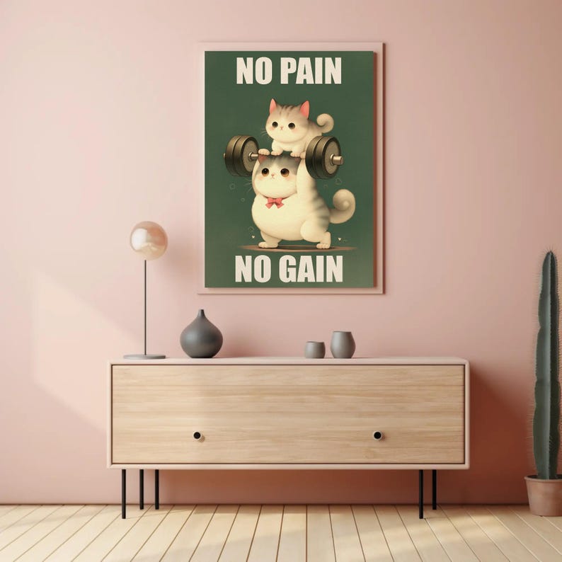 May include: A motivational poster with a green background featuring two cartoon cats lifting weights. The text on the poster reads "No Pain No Gain".