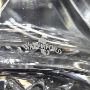 May include: Close-up of a Waterford crystal glass etched with the Waterford logo.