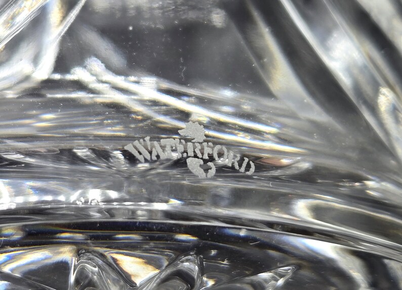 May include: Close-up of a Waterford crystal glass etched with the Waterford logo.