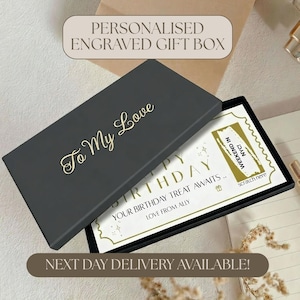 May include: A rectangular black gift box with the gold engraved text To My Love on the lid. Inside, a white card features the text BIRTHDAY, YOUR BIRTHDAY TREAT AWAITS, LOVE FROM ALLY, and a gold scratch-off panel labelled WEEKEND IN NYC.