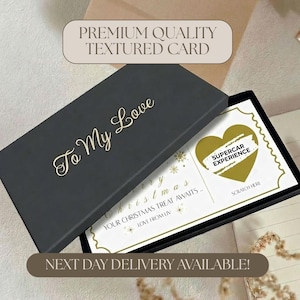 May include: A black rectangular gift box with the gold text To My Love on the lid. Inside is a white rectangular card with gold snowflake accents, the text Merry Christmas Your Christmas Treat Awaits Love From Liv, and a gold heart scratch-off.