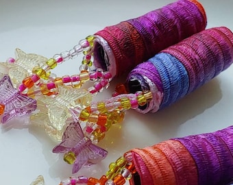 Set of 4 beaded fabric beads. Happy? You bet! Who wouldn't be with a butterfly bum? lightweight dread sleeve tube slide