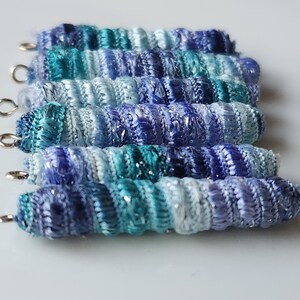 Set of 6 fabric beads. Perriwinkle twinkle. We like it. It sort of rolls off the tongue. Fiber wrap tube