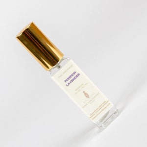May include: A clear glass perfume bottle with a gold cap. The label reads "Pumpkin Lavender" and "Perfume 1 fl oz / 30 ml". The bottle is angled on a white surface.