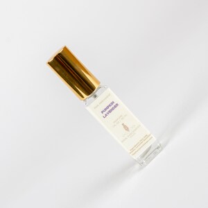May include: A rectangular perfume bottle with a gold cap and a white label. The label reads "Pumpkin Lavender" in purple text. The bottle contains 1 fl oz / 30 ml of perfume. The brand name "Pink Parchment Soaps" is also visible.