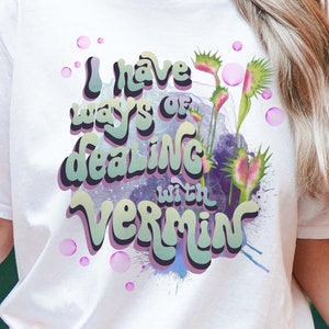 May include: White t-shirt with a graphic of a Venus flytrap and the text "I have ways of dealing with vermin".