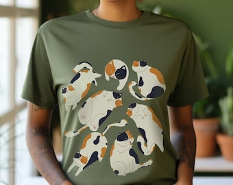 May include: A green t-shirt featuring a print of several calico cats in different positions. The cats are all black, white and orange.