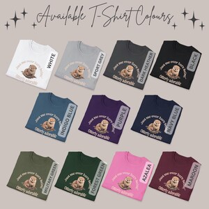 May include: A variety of t-shirt colors with a cute otter graphic and the text "Just me over here being Otterly adorable". The colors include white, sport grey, dark heather, black, indigo blue, purple, navy blue, military green, forest green, azalea, and maroon.
