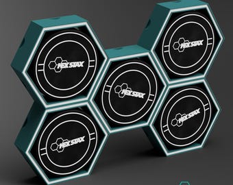 May include: A teal and white hexagonal display unit with six black and white pucks. Each puck has the text "HEX STAX" and a white border. The word "GIANTS" is at the bottom. The display is designed to hold hockey pucks.
