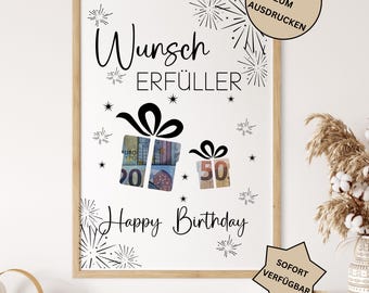 May include: A framed print with the words "Wunsch Erfüller" and "Happy Birthday" in black script. The artwork features gift box illustrations with currency inside, and decorative starbursts. The print includes the text "PDF DATEI ZUM AUSDRUCKEN" and "SOFORT VERFÜGBAR".