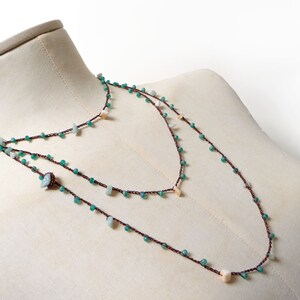 Crochet beaded necklace made with dark copper brown lurex thread + aquamarine and cream white gemstone chips + tiny green glass crystals.