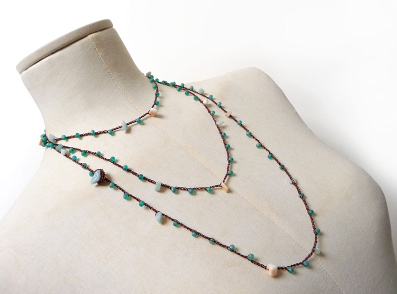 Crochet beaded necklace made with dark copper brown lurex thread + aquamarine and cream white gemstone chips + tiny green glass crystals.