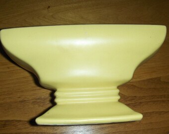 Mc Coy vase in a soft buttery yellow.The second picture is closer to the color. From the 30,s