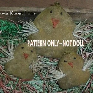 May include: A pattern for making three primitive fabric chicks. The chicks are brown and have a simple embroidered face. The pattern is labeled "PATTERN ONLY--NOT DOLL".