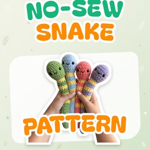 May include: Four plush snakes with striped patterns in green, blue, pink, and purple, each featuring black safety eyes and embroidered smiles. The text NO-SEW SNAKE PATTERN is displayed in large green and orange letters above and below the toys.