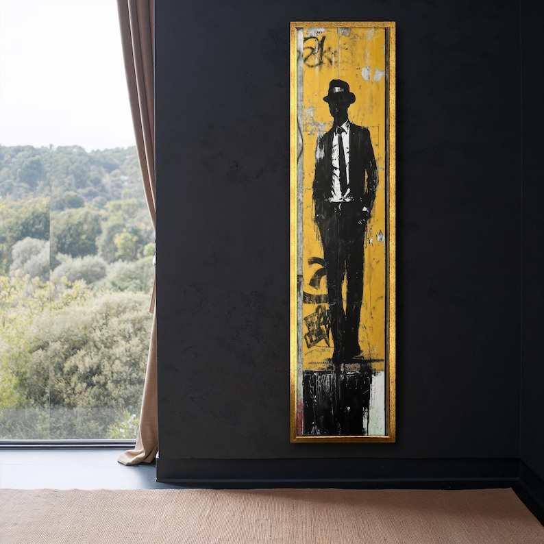 May include: A black and white silhouette of a person wearing a hat and suit standing in front of a yellow and black background. The background is a wooden panel with a gold frame.