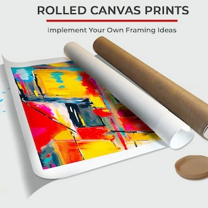 May include: Rolled canvas prints with the text "Implement Your Own Framing Ideas". The image shows a rolled canvas print with an abstract painting in red, yellow, blue, and black. Two rolled canvases are next to the print, one white and one brown.