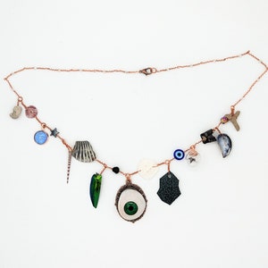 Curio Cabinet on a Charm Necklace with Green Prosthetic eye Centerpiece and Clear Bicone Beads