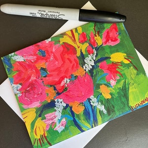 May include: A colorful greeting card featuring a painting of a bouquet of pink, yellow, and white flowers with green leaves and blue stems. The card is signed "GLUSAMANN" in the bottom right corner.