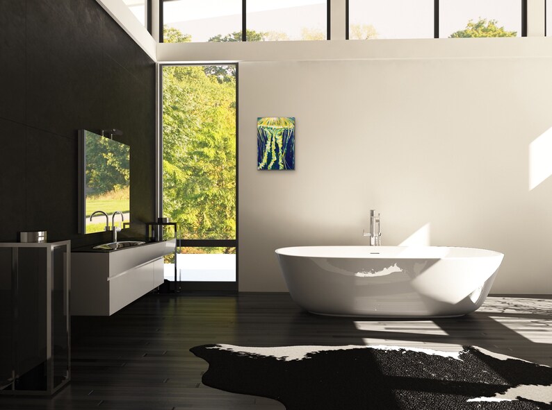 May include: A modern bathroom with a white bathtub, a black and white cowhide rug, and a framed abstract painting on the wall.