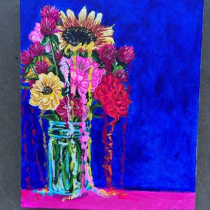 May include: A painting of a bouquet of flowers in a mason jar. The flowers are a mix of pink, red, yellow, and orange. The background is a deep blue. The painting is signed "Sutayah" in the bottom right corner.