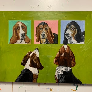 May include: Acrylic painting of Basset Hounds. Three portraits of the dogs are set against a green background, each in a different colored square. Two additional dogs are painted below the portraits, looking up. The painting is on a white canvas.