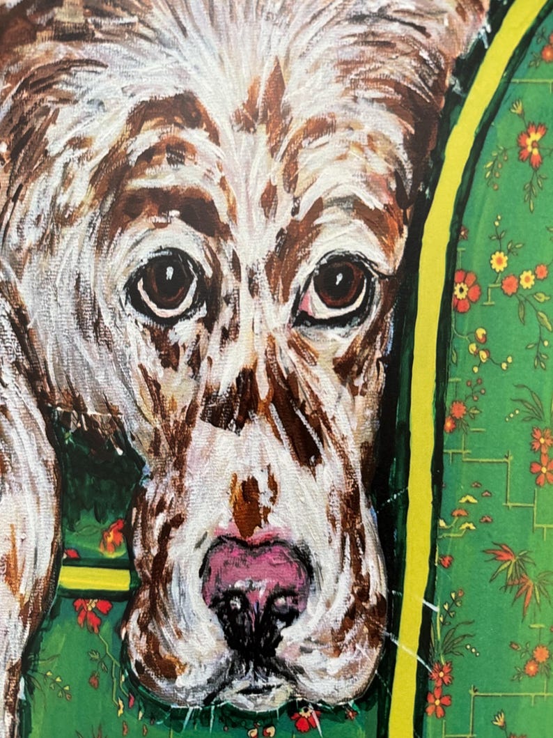 May include: A painting of a dog with brown and white fur, dark brown eyes, and a pink nose. The dog is positioned against a green background featuring a repeating pattern of small red and orange flowers with thin yellow lines framing the scene.