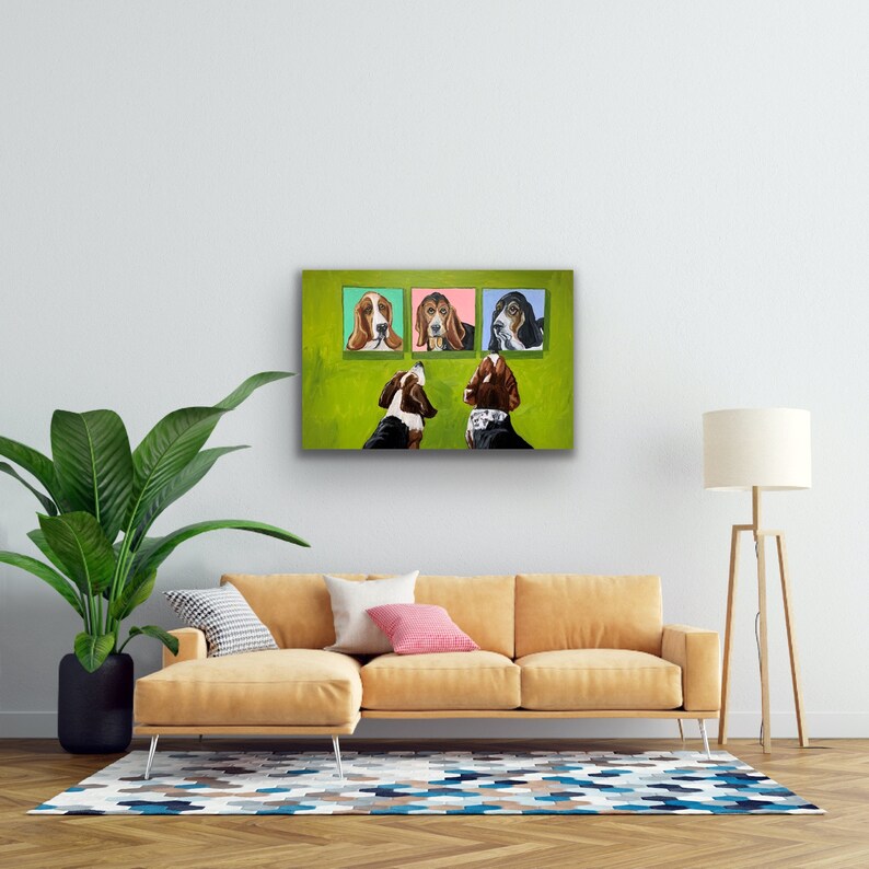May include: A colorful painting of Basset Hounds. The artwork features three dog portraits above two dogs looking up. The background is green, and the portraits have different colored frames. The painting is displayed above a yellow sofa.