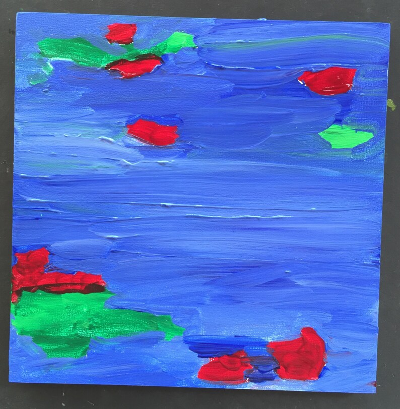 May include: Abstract painting on a blue canvas with red and green shapes. The red shapes are scattered across the canvas, while the green shapes are clustered together in the upper left and lower right corners.