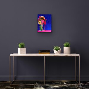 May include: A painting of a bouquet of colorful flowers in a glass jar, set against a dark blue background. The flowers include sunflowers, pink and red roses, and other blooms.