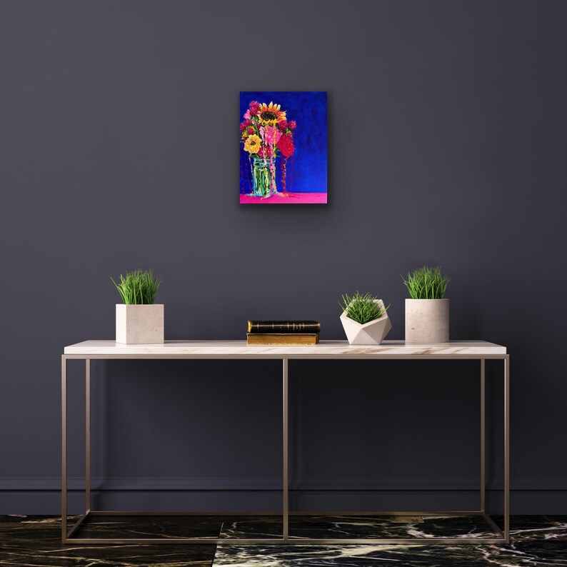 May include: A painting of a bouquet of colorful flowers in a glass jar, set against a dark blue background. The flowers include sunflowers, pink and red roses, and other blooms.