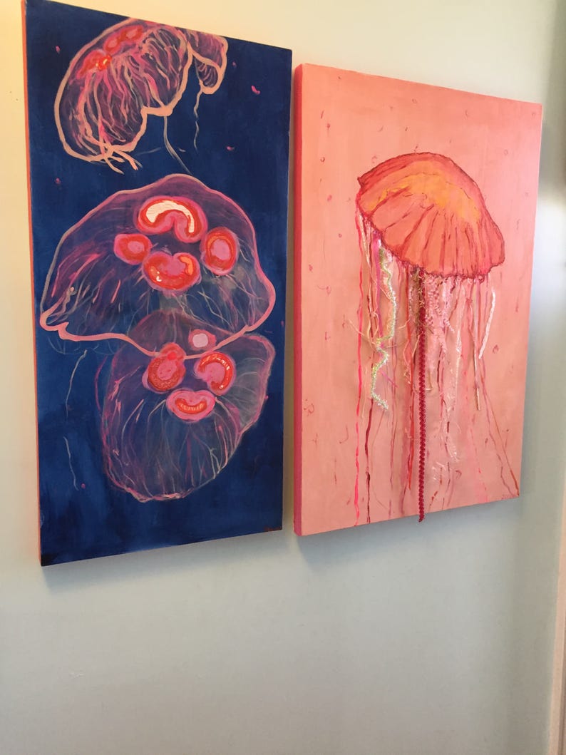 May include: Two paintings of jellyfish, one with a blue background and two jellyfish, the other with a pink background and one jellyfish.