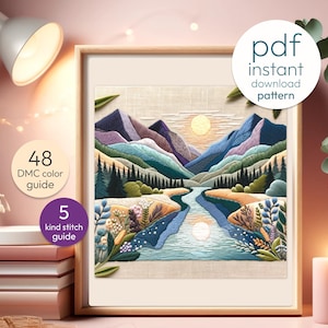 May include: A framed cross-stitch landscape depicting mountains, a river, and a sun, in shades of blue, green, and purple. The frame is light brown. The image includes text that says "pdf instant download pattern", "48 DMC colour guide", and "5 kind stitch guide".