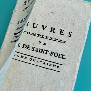 May include: A vintage book titled "OEUVRES COMPLETTES DE 1. DE SAINT-FOIX. TOME QUATRIEME."