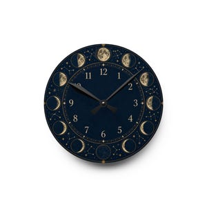 May include: A round wall clock with a dark navy blue face featuring gold-colored numerals from 1 to 12. The outer border displays a sequence of lunar phases and constellations in gold and cream tones. Two black hands indicate the time on the clock.