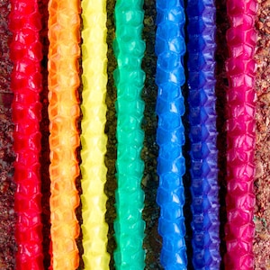 Image shows a rainbow set of birthday candles.