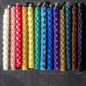 Image shows rolled beeswax birthday candles in the entire color range available from Pumpkin Plus Bear.