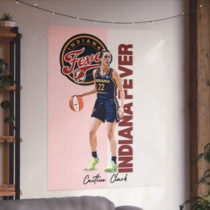May include: Poster featuring Caitlin Clark of the Indiana Fever. The poster has a pink and white background with the team logo and the words "INDIANA FEVER" in maroon. Clark is wearing a navy blue uniform and holding a basketball.