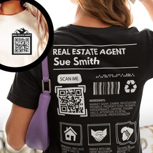 May include: Black t-shirt with a white design that says "REAL ESTATE AGENT Sue Smith" with a scannable QR code and a barcode. The design also includes icons for a house, a handshake, and a hand holding a key.