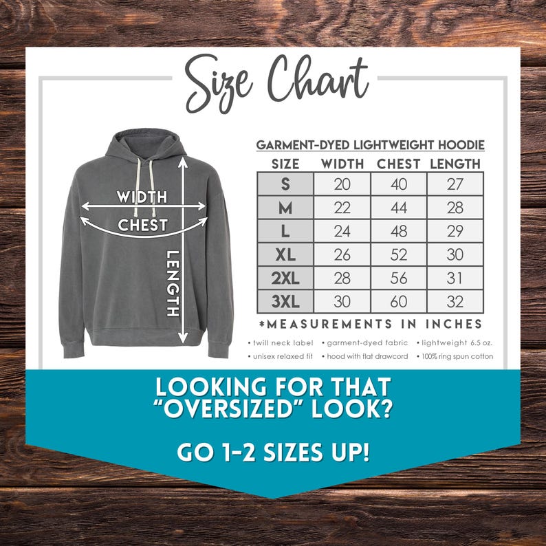 May include: Size chart for a garment-dyed lightweight hoodie. The chart shows the width, chest, and length measurements in inches for sizes S through 3XL. The chart also includes information about the fabric and fit of the hoodie. The text "Looking for that "oversized" look? Go 1-2 sizes up!" is displayed below the chart.