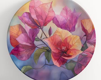 Può includere: Un piatto decorativo rotondo con un design floreale ad acquerello. Il piatto presenta vibranti fiori di bouganville rosa, arancioni e viola con foglie verdi su uno sfondo morbido e multicolore. Il design è artistico e dettagliato.