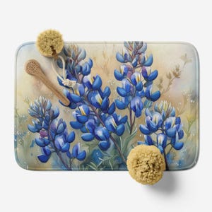May include: A watercolor painting of bluebonnet flowers on a beige background. The flowers are in full bloom and have a delicate, watercolor effect. The background is a soft, muted beige.