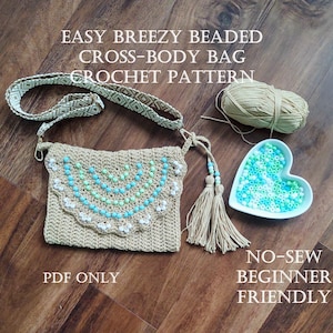 May include: A crochet pattern for a beaded cross-body bag. The pattern is described as easy, breezy, and beginner-friendly. The image shows a crocheted bag with a beaded design, a skein of yarn, and a bowl of beads. The text on the image reads "Easy Breezy Beaded Cross-Body Bag Crochet Pattern", "PDF Only", and "No-Sew Beginner Friendly".